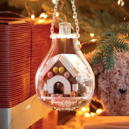 Boule de Noël lumineuse avec maison en briques colorées
